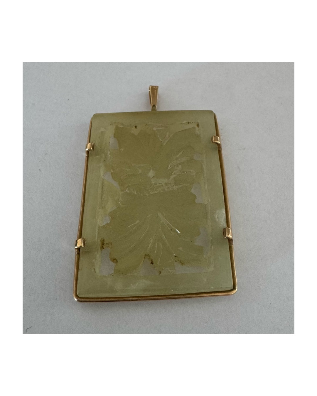 14K gold rectangular pendant set with a hand-carved milky Jade stone