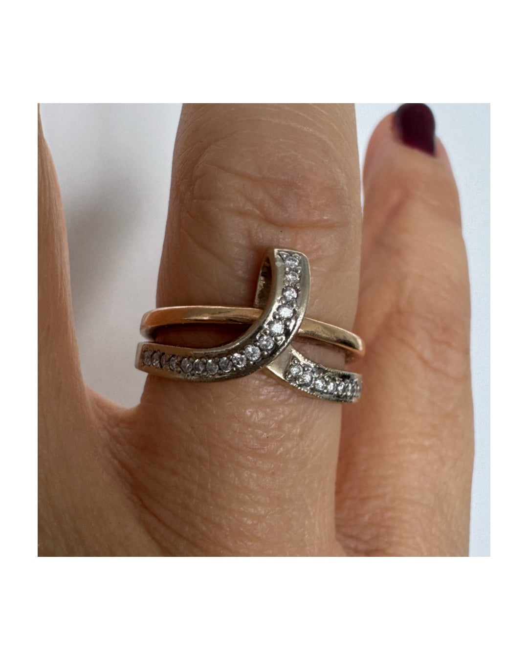 18K two-tone gold (rose & white) crossover ring featuring a row of sparkling Diamonds along each band, creating an elegant and modern design.