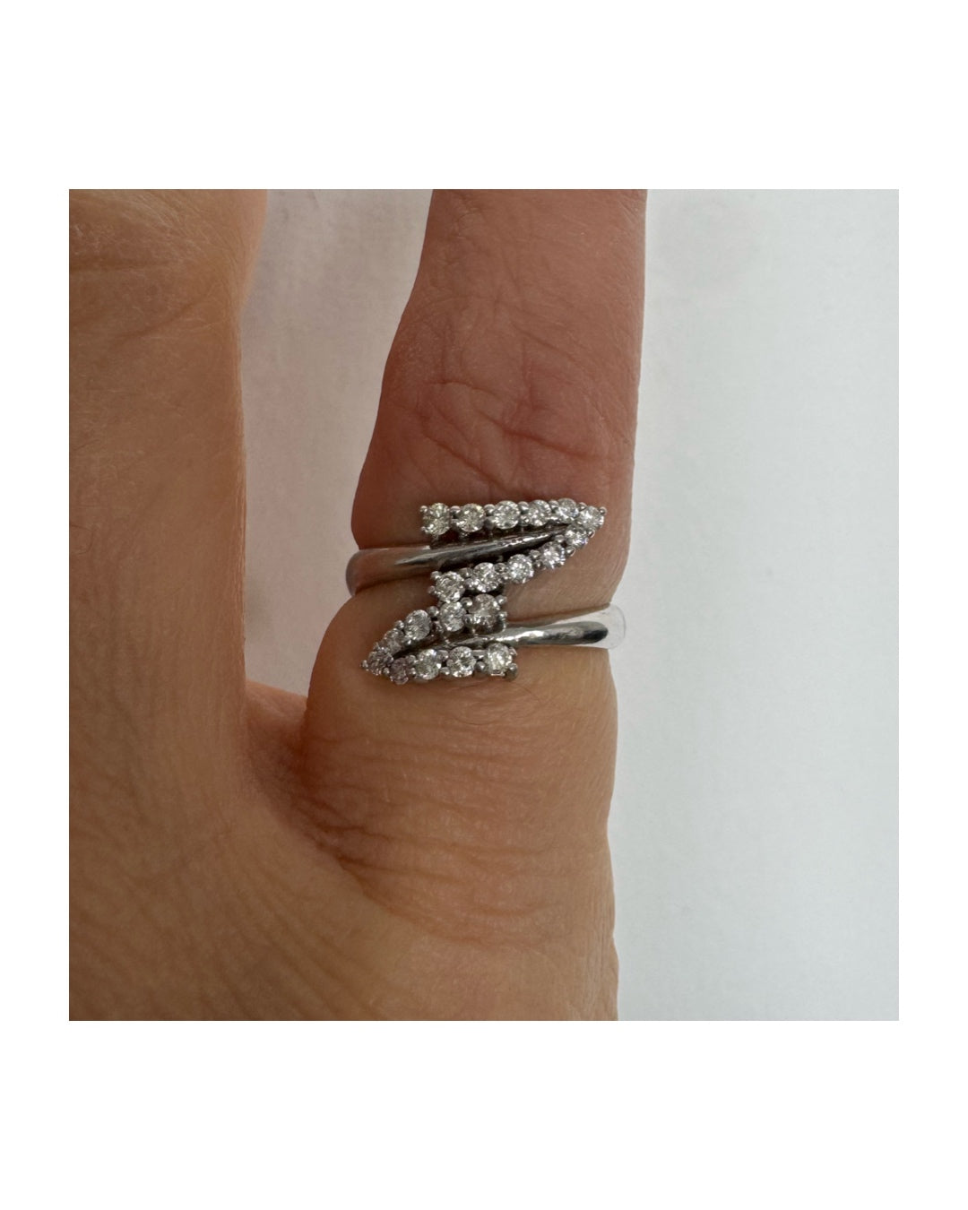 14K gold ring with an open design, featuring two curved rows of sparkling Diamonds that cross over each other elegantly.