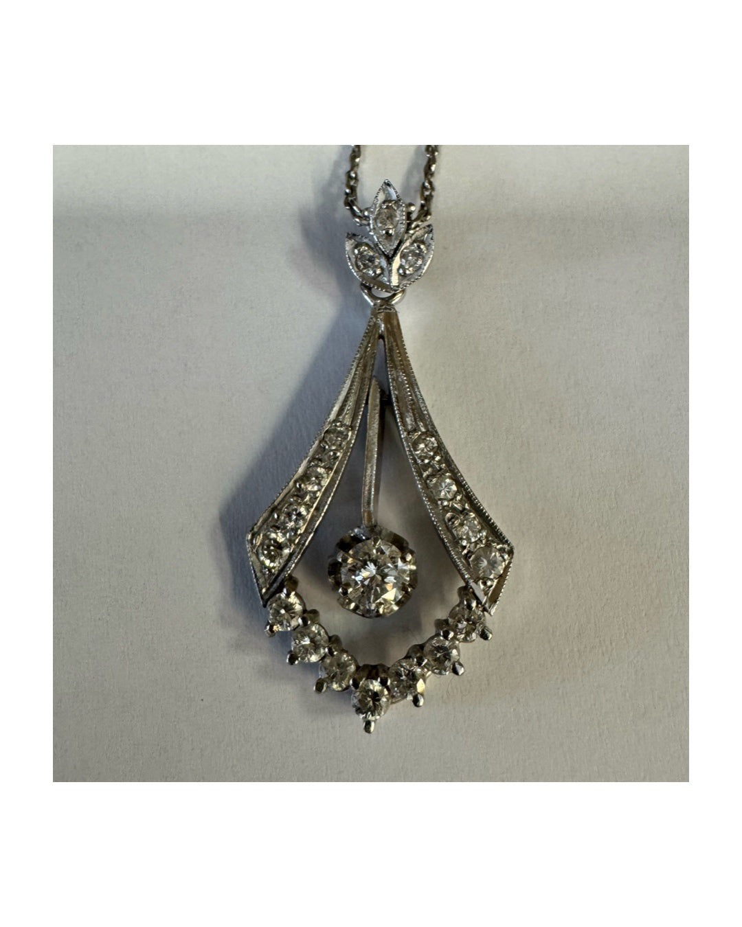 14K gold Diamond pendant with a timeless silhouette and a subtle Art-Deco touch.