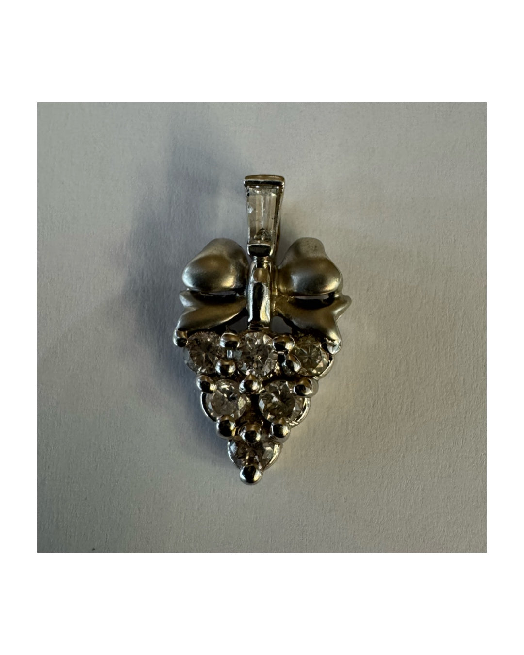 18K gold pendant, crafted in a timeless grape cluster design and set with sparkling diamonds.